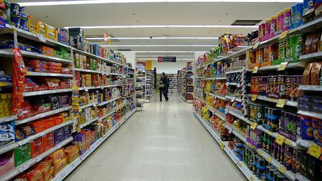bright grocery store aisle filled with colorful snacks and a shopper exploring the selections.