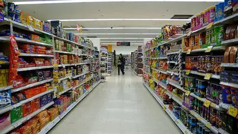 In The Market For A Managed Services Provider To Support Your Business Computer Network? 4 bright grocery store aisle filled with colorful snacks and a shopper exploring the selections.