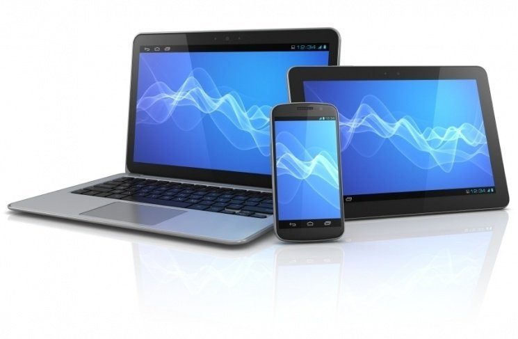 showcasing a laptop, tablet, and smartphone on a reflective surface with vibrant blue designs.