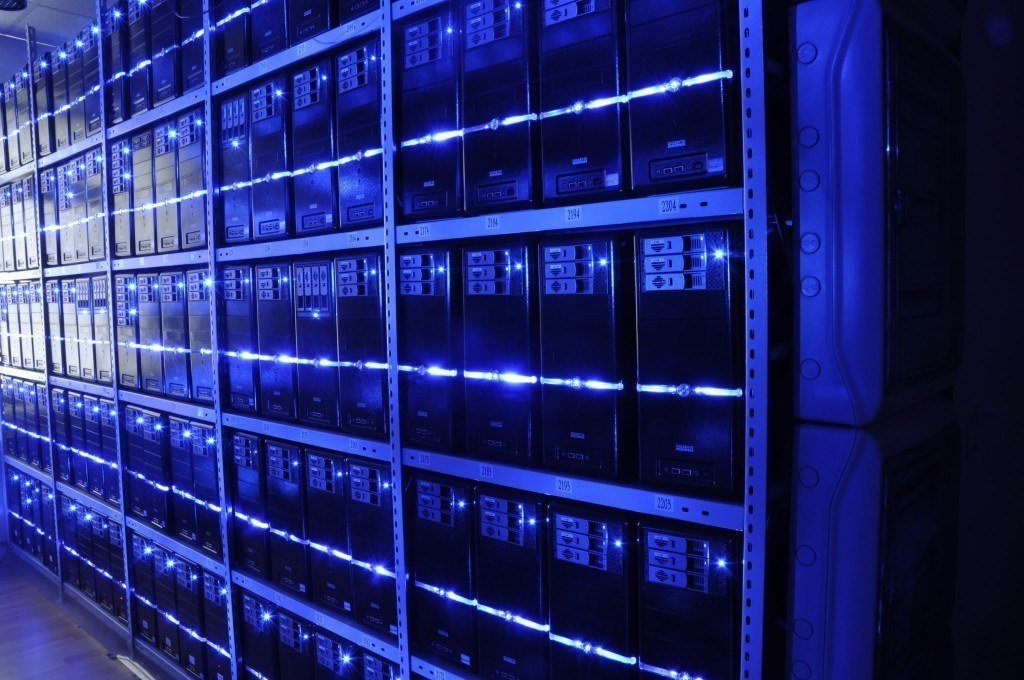 organized data center with sleek black server racks and vibrant blue led lighting.