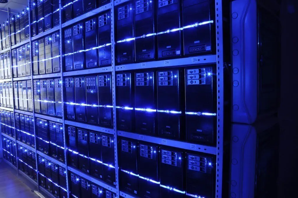 organized data center with sleek black server racks and vibrant blue led lighting.