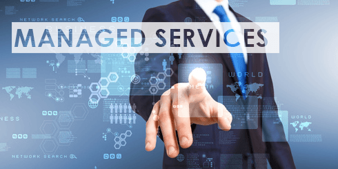 professional man in suit highlights managed services benefits against a tech-inspired digital background.