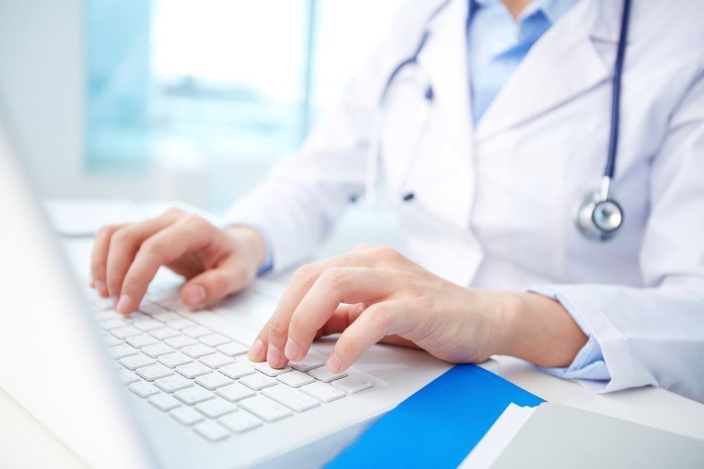 healthcare professional using technology for patient documentation in a modern clinic setting.