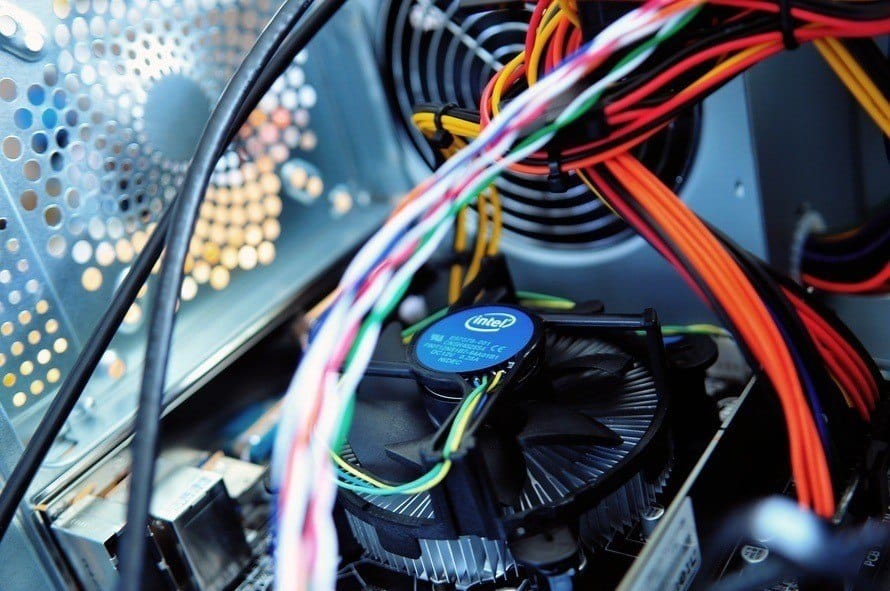 close-up of computer components featuring intel cpu cooler and intricate wiring for optimal performance.
