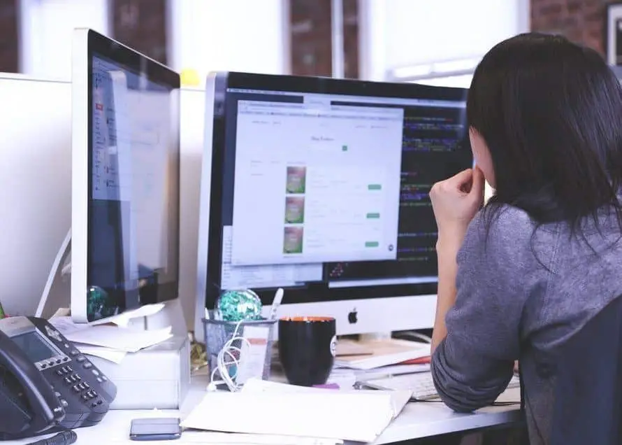 How To Save On It Support For Small Businesses 3 focused professional at a modern desk optimizing it support for small businesses.