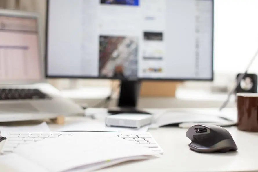 modern workspace with sleek monitor, ergonomic mouse, and natural light for productivity and comfort.