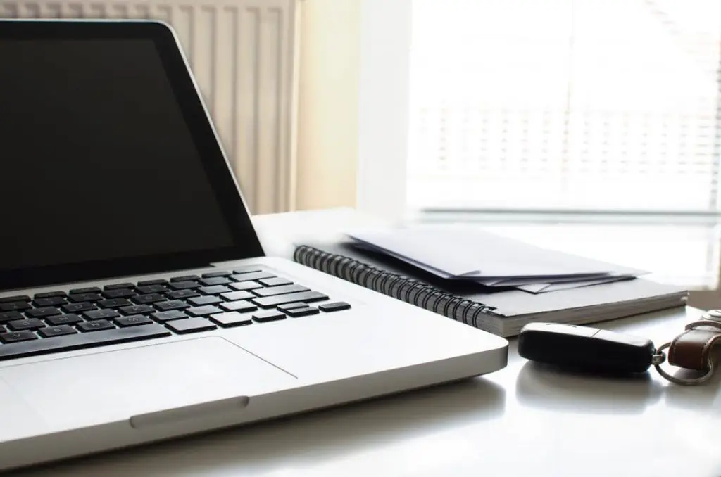 Computer Security: Don'T Use The Same Password For Multiple Accounts 6 minimalist workspace with a silver laptop, notebooks, and natural light for enhanced productivity.