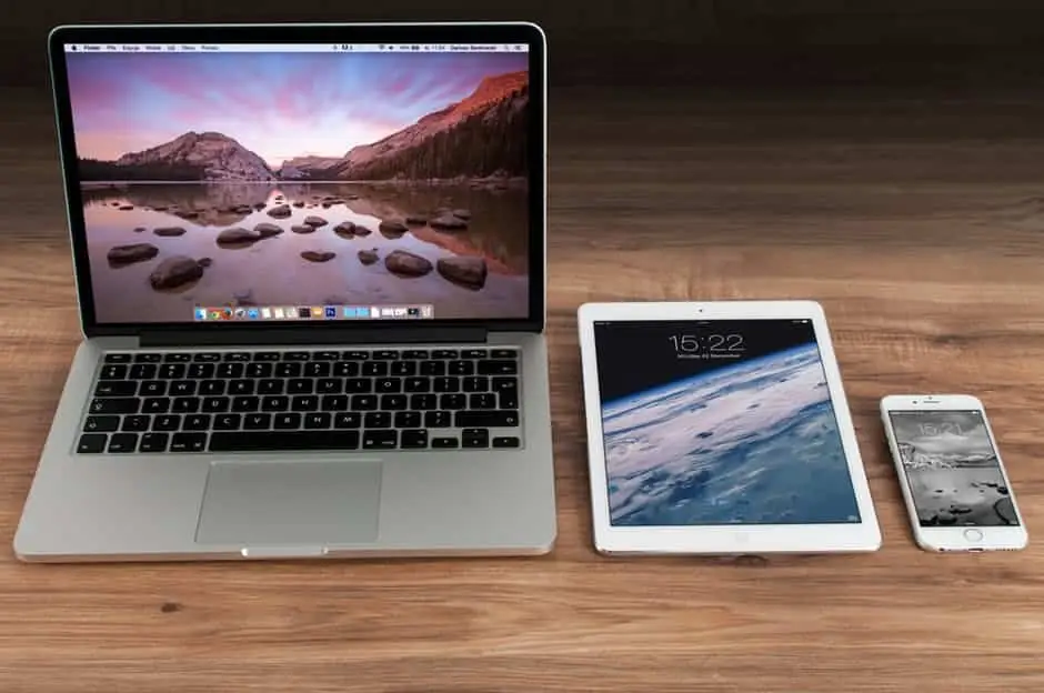 To Boost Productivity, Have You Tried Automation Apps For Multitasking? 2 sleek apple devices on a wooden surface, showcasing modern productivity and tranquility in design.