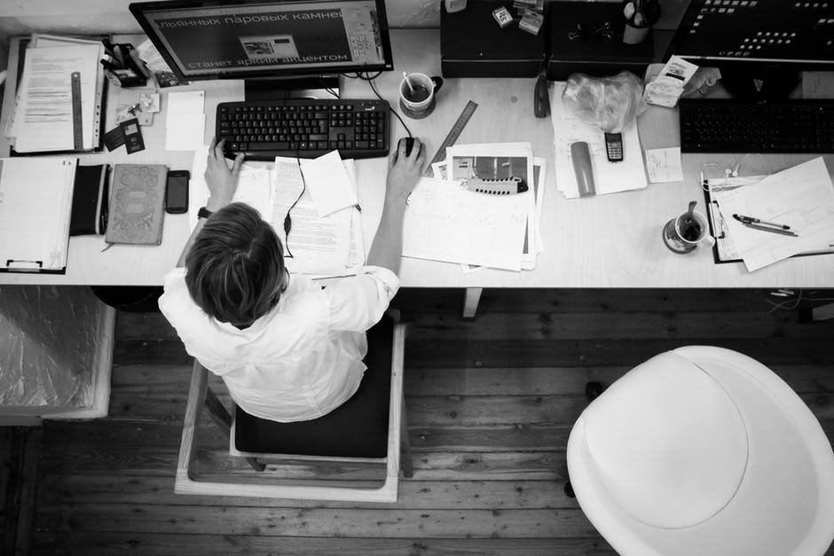 productive workspace with computer, papers, and tools emphasizing efficient work habits.