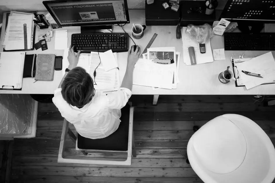 productive workspace with computer, papers, and tools emphasizing efficient work habits.