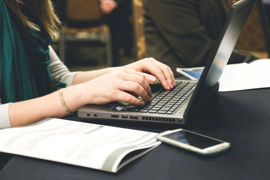 professional woman engaged in effective it service management discussions while using a laptop.