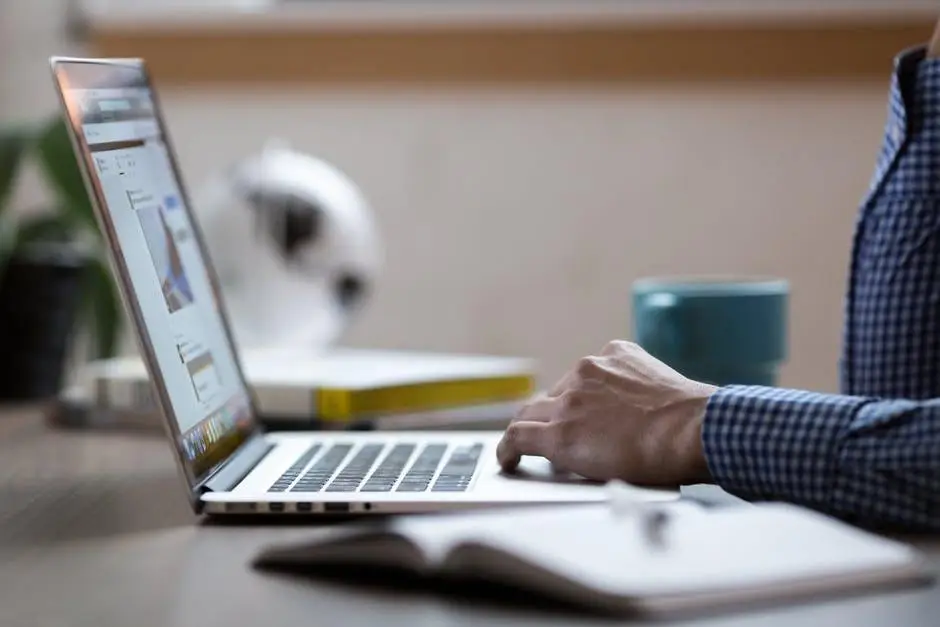 Hire The Network Support Services Your Business Needs For Growth 5 cozy workspace with laptop, notebook, plant, and mug, perfect for productivity and creativity.