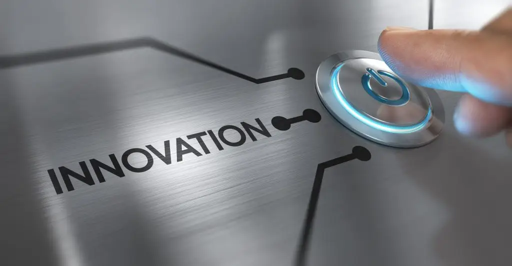 Will New Technology Really Change Work And Home? 1 a finger hovers over an illuminated button on a sleek metallic interface labeled innovation.