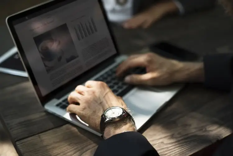 Online Identity: Understanding And Keeping It Secure 1 professional man working on a laptop outdoors, blending productivity with a relaxed environment.