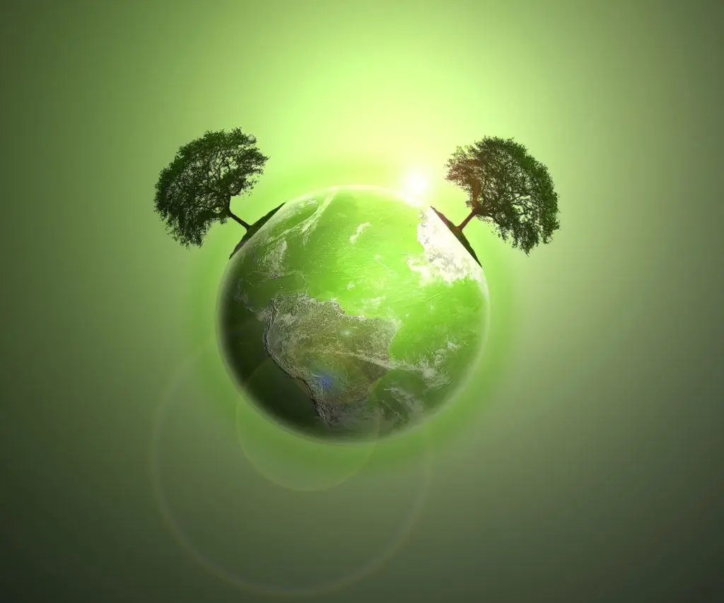 vibrant green globe with protective trees, symbolizing environmental awareness and sustainability.