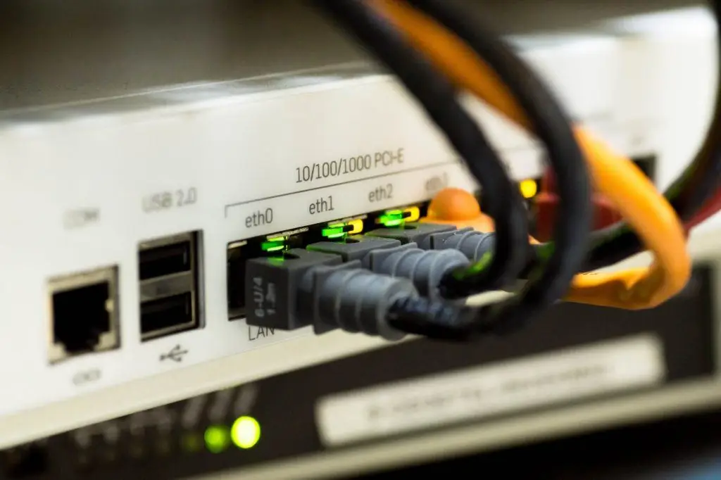 It Service Management In A Nutshell 5 close-up of a network switch with ethernet ports and organized, color-coded cables.