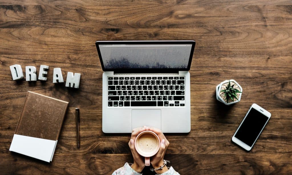 inviting workspace with laptop, decorative items, and cozy mug for creativity and inspiration.