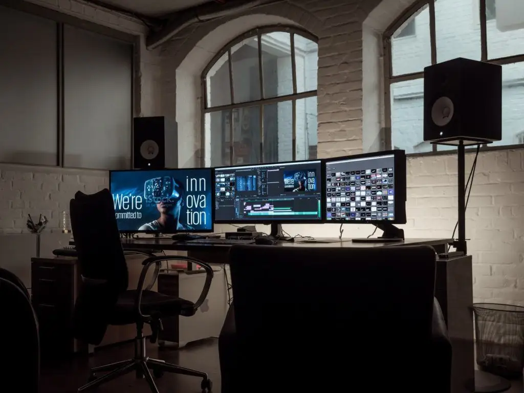 Tips For Protecting Your Office Computer 1 modern workspace with dual monitors, ergonomic chair, natural light, and creative ambiance.