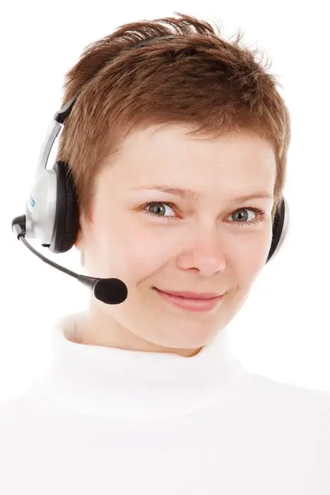 cheerful support agent wearing a headset, ready to assist customers with a warm smile.