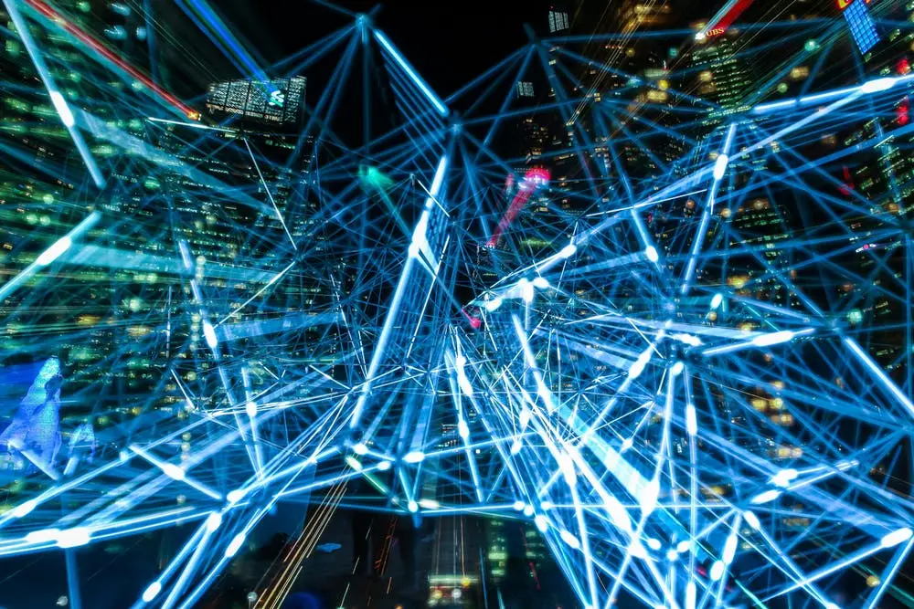 Microsoft Teams Adds New Functionality In 2019 5 abstract blue network lines symbolize digital connectivity within a vibrant urban landscape.