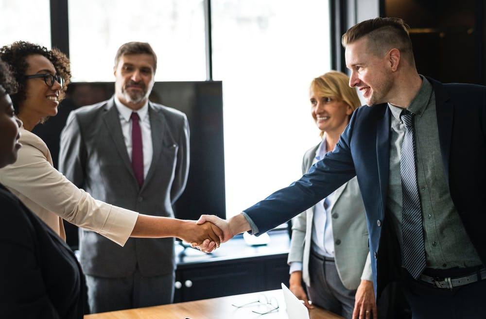 professional handshake symbolizes collaboration and agreement in a modern office setting.
