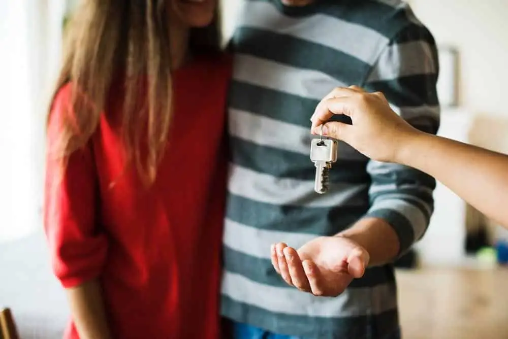 Business Continuity - One Of The Keys To Maintaining Success 4 a joyful couple exchanges keys, celebrating new beginnings in their cozy home.