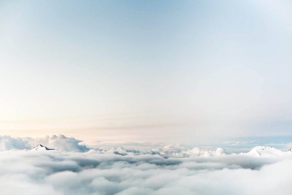 a serene aerial view of fluffy clouds and a calming blue sky.