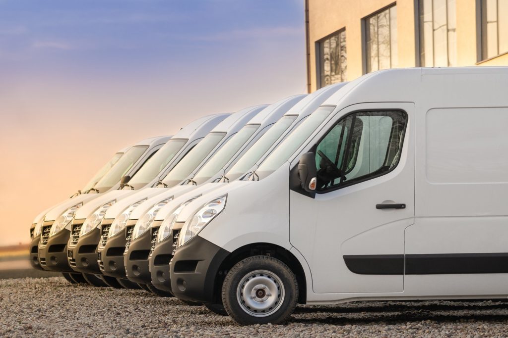 neatly parked white delivery vans reflect professionalism and readiness in a commercial setting.