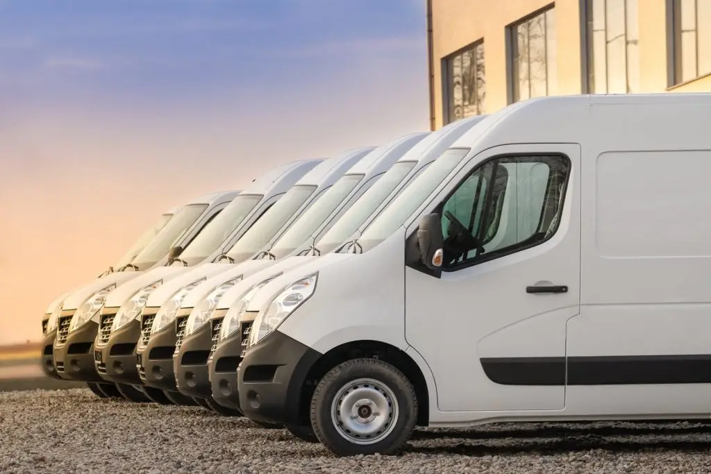 neatly parked white delivery vans reflect professionalism and readiness in a commercial setting.