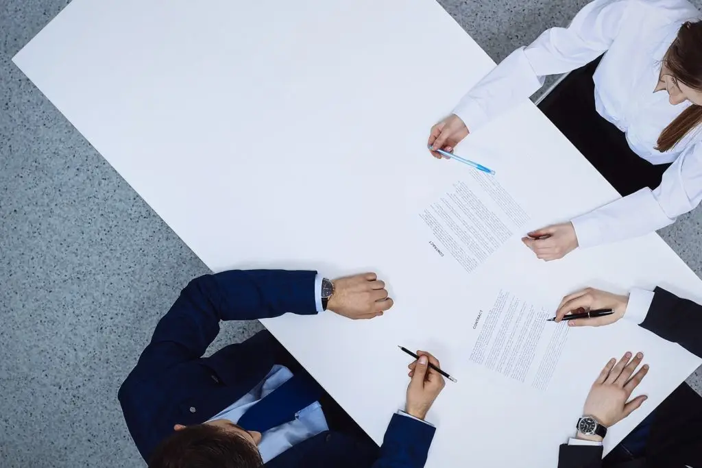professionals collaborating at a conference table during a focused meeting.