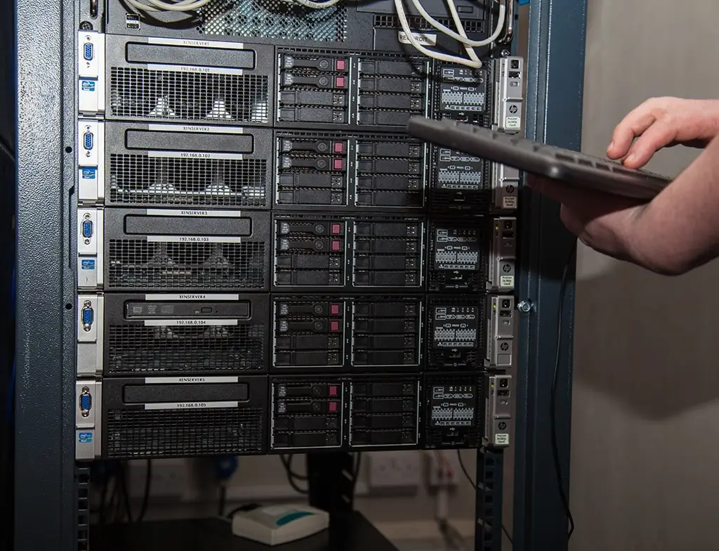 technician managing a sleek server rack in a data center with organized cabling system.
