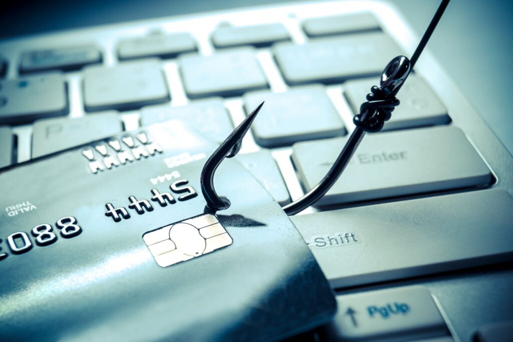 credit card hooked as a metaphor for phishing threats in online security.