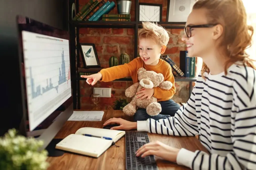 mother and son joyfully explore together in a cozy workspace with rustic charm.