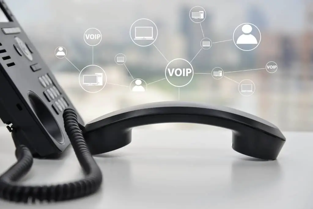 Voip: A Game Changer For Business Communications 1 sleek voip phone on a desk, showcasing modern communication in a vibrant office setting.