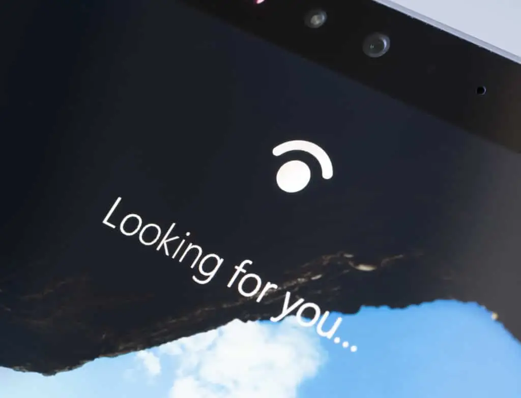 close-up of surface pro screen displaying looking for you… with windows hello feature.