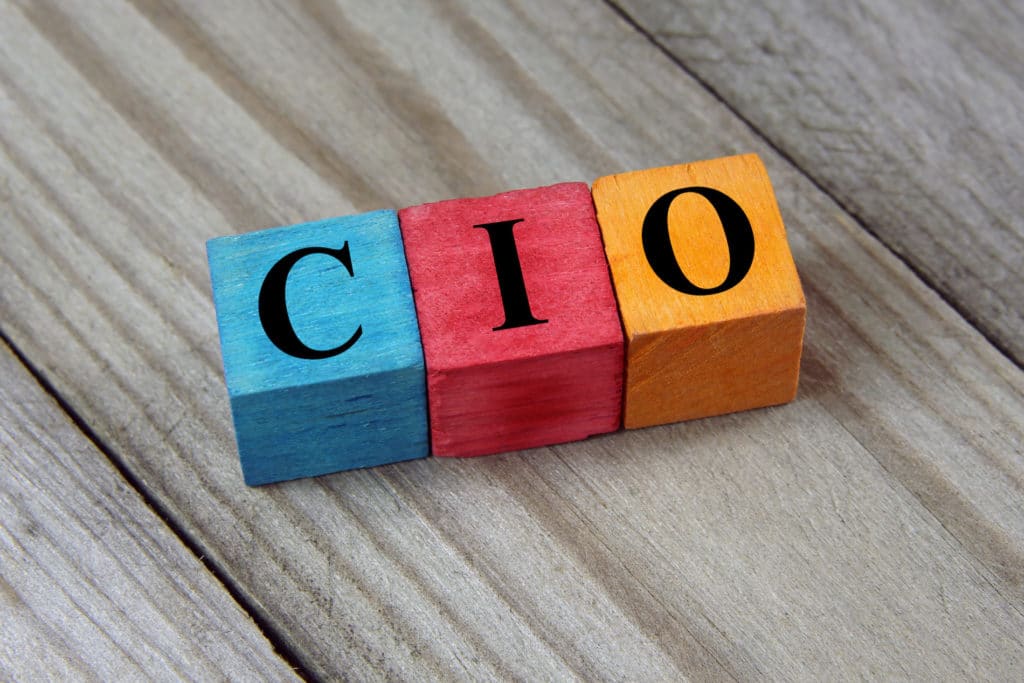 colorful wooden blocks spelling cio, representing technology leadership on a rustic wood surface.