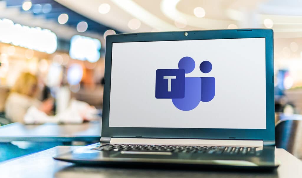 sleek laptop displaying microsoft teams logo, set in a stylish workspace for remote collaboration.