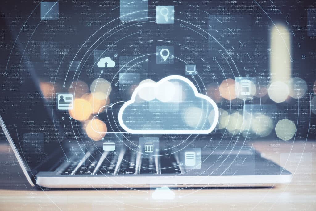 sleek laptop showcasing cloud computing icons in a warm, modern workspace ambiance.