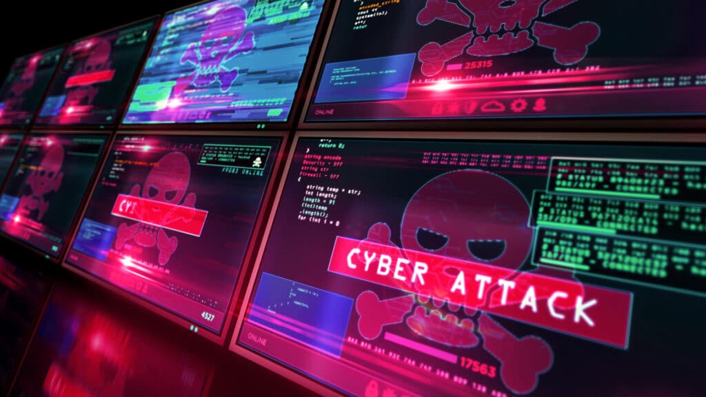 high-tech control room displaying cyber attack warning and ominous skull symbol on computer screens.