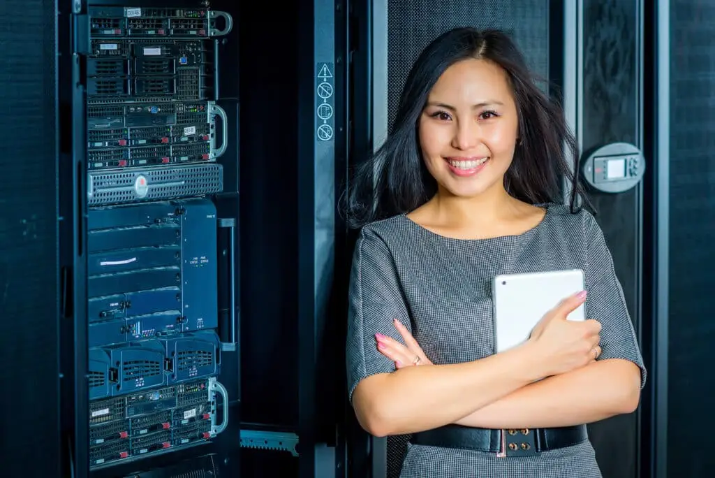 Mastering The Clock And The Wallet: It Service Management'S Dual Impact 1 confident woman in a tech setting, showcasing empowerment and diversity in the industry.