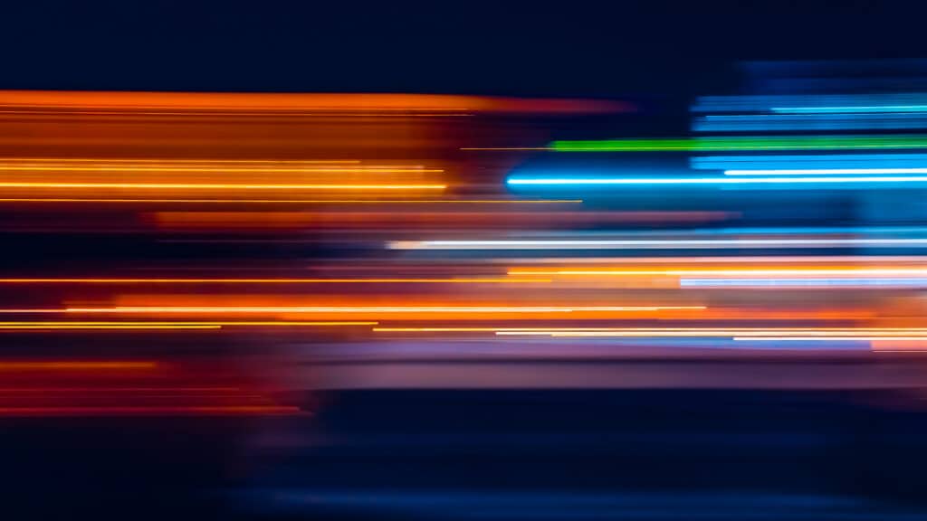 dynamic light streaks in vibrant oranges and blues capture urban energy and motion.